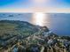 Stunning aerial view of waterfront homes along a scenic coastline with Tampa Bay in the distance at 523 Georgia Ave, Crystal Beach, FL 34681