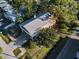 Aerial view of home showcasing its location, roof, yard, porch, and proximity to the street at 523 Georgia Ave, Crystal Beach, FL 34681