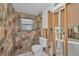 Rustic bathroom boasts unique stone wall shower and tiled flooring at 523 Georgia Ave, Crystal Beach, FL 34681