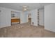 An airy bedroom with mirrored closet, neutral carpet, and a ceiling fan at 523 Georgia Ave, Crystal Beach, FL 34681