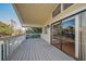 Spacious covered deck with sliding glass doors and wooden railing offering serene views at 523 Georgia Ave, Crystal Beach, FL 34681