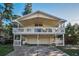 Charming two-story beach home with a large front porch and a two-car garage underneath at 523 Georgia Ave, Crystal Beach, FL 34681