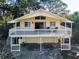 Charming two-story beach home with a large front porch and a two-car garage underneath at 523 Georgia Ave, Crystal Beach, FL 34681