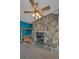 Close up shot of a stone fireplace with a decorative mantle and a view into another room at 523 Georgia Ave, Crystal Beach, FL 34681