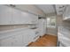 Functional kitchen equipped with white appliances, ample countertop space, and natural light from the window at 523 Georgia Ave, Crystal Beach, FL 34681