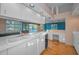 Modern kitchen featuring white cabinetry, a central island, and views of the adjacent living spaces at 523 Georgia Ave, Crystal Beach, FL 34681