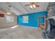 Bright living room with a stone fireplace, textured wall, and large windows at 523 Georgia Ave, Crystal Beach, FL 34681