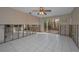 Bright living room features tiled floors, ceiling fan, and sliding glass doors to the backyard at 523 Georgia Ave, Crystal Beach, FL 34681