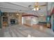 Spacious living room with a stone fireplace, wood flooring and exposed beam ceilings at 523 Georgia Ave, Crystal Beach, FL 34681