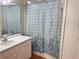 Bathroom with a shower/tub combo and a patterned shower curtain at 5607 Tanagergrove Way, Lithia, FL 33547