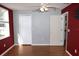 A bedroom shows vaulted ceilings, hardwood floors, a window and modern color scheme at 5607 Tanagergrove Way, Lithia, FL 33547