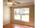 Bedroom with neutral walls, tile flooring, ceiling fan, and a window with backyard views at 5607 Tanagergrove Way, Lithia, FL 33547