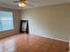 Simple bedroom with tile floors and a large window with blinds at 5607 Tanagergrove Way, Lithia, FL 33547