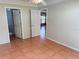 Bedroom with tile floors, a door to the bathroom, and access to another room at 5607 Tanagergrove Way, Lithia, FL 33547