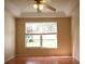 Bedroom with neutral walls, tile flooring, ceiling fan, and a window with backyard views at 5607 Tanagergrove Way, Lithia, FL 33547