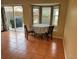 Small dining area with a round table and chairs, near a sliding glass door at 5607 Tanagergrove Way, Lithia, FL 33547