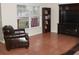 Living room showcasing tile floors, a large window with natural light, and a comfortable leather chair at 5607 Tanagergrove Way, Lithia, FL 33547