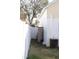 Side yard with white fence, exterior storage unit, and air conditioner at 5607 Tanagergrove Way, Lithia, FL 33547