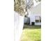 Fenced side yard featuring grass, storage shed, and an air conditioning unit at 5607 Tanagergrove Way, Lithia, FL 33547