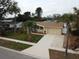 Single-story house with updated landscaping and driveway at 5611 Riddle Rd, Holiday, FL 34690