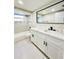 Modern bathroom featuring double vanity, sleek fixtures, and tiled tub-shower combo at 5611 Riddle Rd, Holiday, FL 34690