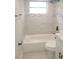 Updated bathroom with tiled shower and bathtub at 5611 Riddle Rd, Holiday, FL 34690