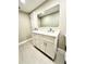 Bathroom vanity with a large mirror, neutral paint and modern cabinets at 5611 Riddle Rd, Holiday, FL 34690