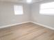 Bright bedroom with neutral walls and wood-look flooring at 5611 Riddle Rd, Holiday, FL 34690