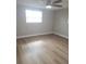 Bright bedroom with ceiling fan and laminate wood floor at 5611 Riddle Rd, Holiday, FL 34690