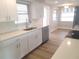 Modern kitchen with white cabinets, stainless steel appliances, and quartz countertops at 5611 Riddle Rd, Holiday, FL 34690