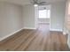 Bright living room featuring wood-look flooring and ceiling fan at 5611 Riddle Rd, Holiday, FL 34690