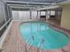 Inviting kidney-shaped pool with brick deck and screened enclosure at 5611 Riddle Rd, Holiday, FL 34690