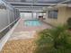 Relaxing pool area with screened enclosure and brick pavers at 5611 Riddle Rd, Holiday, FL 34690