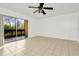 Bedroom with tile floors, sliding doors to balcony, and ceiling fan at 603 N Keene Rd # P12, Clearwater, FL 33755