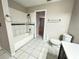 Bright bathroom featuring a shower-tub combo, toilet, tile flooring, and vanity with ample counter space at 6441 Drexel Dr # 7, Port Richey, FL 34668
