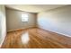 Spacious bedroom with hardwood flooring and a window that fills the room with natural light at 6441 Drexel Dr # 7, Port Richey, FL 34668