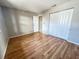 Bedroom with hardwood floors, closet with double doors, and natural light, offering a comfortable living space at 6441 Drexel Dr # 7, Port Richey, FL 34668