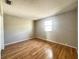 Bedroom featuring hardwood floors and a bright window, creating a comfortable and inviting atmosphere at 6441 Drexel Dr # 7, Port Richey, FL 34668