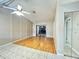 Open living area with hardwood flooring, fan and access to patio via sliding glass door at 6441 Drexel Dr # 7, Port Richey, FL 34668