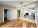 Inviting open-concept living space with a view into the kitchen, featuring beautiful hardwood floors at 6441 Drexel Dr # 7, Port Richey, FL 34668