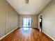 Spacious living room featuring hardwood flooring and a sliding glass door to the backyard at 6441 Drexel Dr # 7, Port Richey, FL 34668
