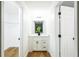 Clean and modern bathroom with white vanity and wood-look floors at 6514 Mariner Blvd, Spring Hill, FL 34609