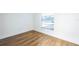 Simple bedroom with wood-look floors and large window at 6514 Mariner Blvd, Spring Hill, FL 34609