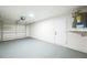 Garage with painted floor, overhead door, and storage at 6514 Mariner Blvd, Spring Hill, FL 34609