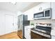 Stainless steel appliances and white cabinets in this galley-style kitchen at 6514 Mariner Blvd, Spring Hill, FL 34609