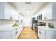 Modern kitchen featuring white shaker cabinets, stainless steel appliances, and quartz countertops at 6514 Mariner Blvd, Spring Hill, FL 34609