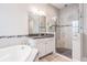 Bathroom features a soaking tub, walk-in shower, and double vanity at 6648 Sunset Vista Way, Land O Lakes, FL 34637