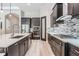 Spacious kitchen featuring dark wood cabinets, an island, and a walk-in pantry at 6648 Sunset Vista Way, Land O Lakes, FL 34637