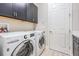 Laundry room with LG washer and dryer, and plenty of cabinet space at 6648 Sunset Vista Way, Land O Lakes, FL 34637