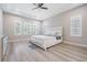 Spacious main bedroom with wood-look floors and large windows at 6648 Sunset Vista Way, Land O Lakes, FL 34637